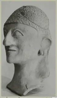 Terracotta head of a man from Ayia Irini, wearing a cap decorated with rows of circular impressions