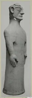 Terracotta statue of a tall standing figure with a long neck and head in profile, from Ayia Irini