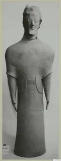 Terracotta statuette of a standing figure with a rounded head, short projecting arms and a tall cylindrical body
