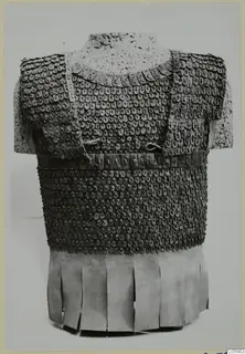 Scale armour corselet with a fringed skirt of strips, shown on a torso stand.