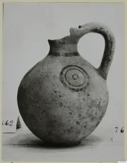 Pottery White Painted IV jug with a strap handle and concentric circles painted on its body.