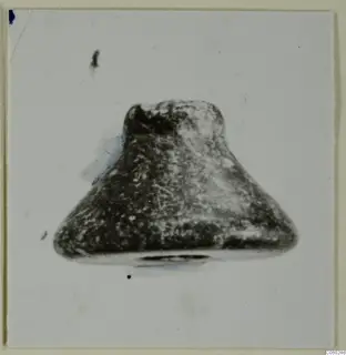 Small find from Idalion: a single object with a broad flat base tapering to a narrower top, on a pale background