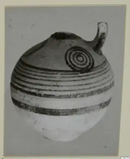 Pottery White Painted IV vessel with a loop handle, painted bands and a concentric-circle motif