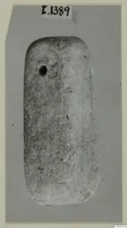 Rectangular stone object with rounded corners and a small hole near its upper left