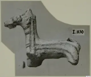 Terracotta animal figurine with an upright head, long neck and dark painted bands, seen in side view