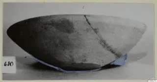 Plain White bowl from Idalion, photographed from the side, with a long crack running down the wall