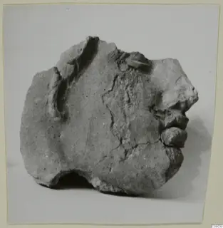 Fragment of a head from Mersinaki, showing nose, lips and chin in profile, with a broken and chipped surface.