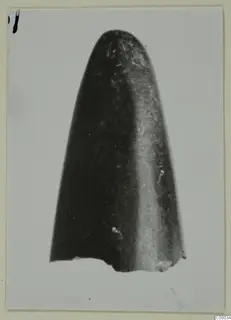 Single worked object with a rounded tip and a broken base, shown upright on a pale background