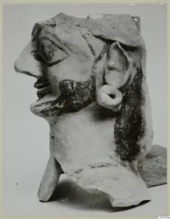 Terracotta head with painted beard and hair, shown in profile, from Ayia Irini