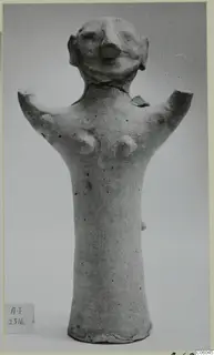 Terracotta figurine with short broken arm stubs, a rounded head with a large nose and ear-like projections