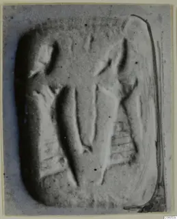 Rectangular glyptic object with raised and incised motifs, photographed flat