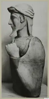 Terracotta Proto-Cypriote II, a bearded head and upper body in profile, one hand raised to the chest