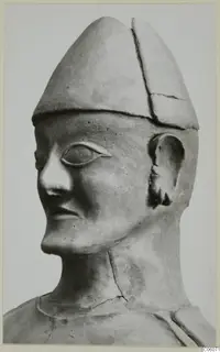 Terracotta Proto-Cypriote I: a statue head and neck in three-quarter view, wearing a tall conical cap