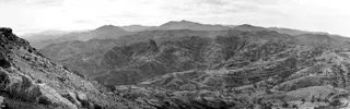 Panoramic view from Vouni looking south over hills, terraced slopes and a winding road