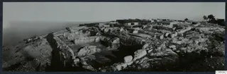 Excavated remains of the palace at Vouni on a hilltop, with the sea hazy at the left edge