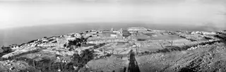 Ruins of the palace at Vouni on a coastal headland, seen from the south-west, with the sea beyond.
