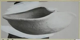 Terracotta lamp, an open boat-shaped clay vessel with a pointed end, photographed against a grey backdrop