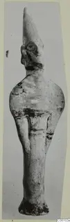 Terracotta statuette from Ayia Irini, a standing figure with a tall pointed headdress and a flared base