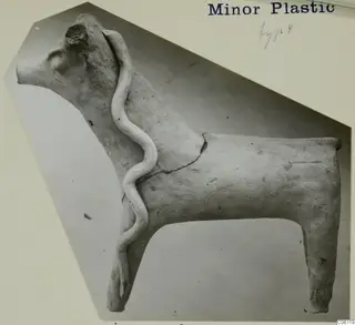 Terracotta figurine of a horned animal, probably cattle, with a wavy clay strip across its body