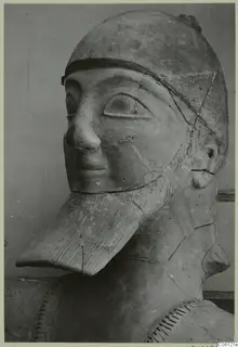 Terracotta Neo-Cypriote statue: bearded head in a dotted cap, seen from a three-quarter angle