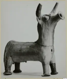 Terracotta figurine of a four-legged animal with tubular projections rising from its head