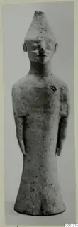 Terracotta figurine of a standing figure with a tall conical head and arms held at its sides