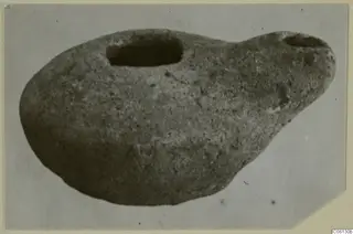 Terracotta lamp from Soli, with a large filling hole and a smaller spout-like opening at one end.