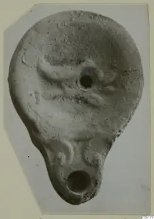 Terracotta oil lamp with a filling hole on top and a nozzle at the lower end.