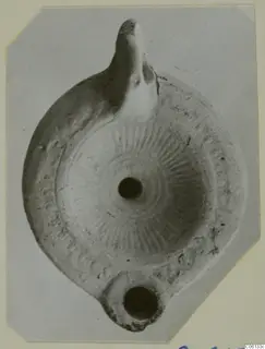 Terracotta oil lamp from Soli with a radiating pattern on the disc, seen from above.