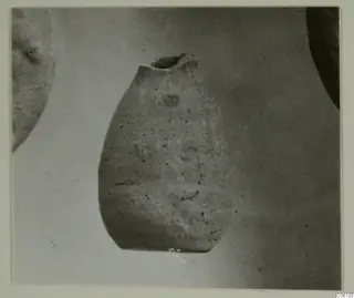 Hellenistic wares: a pottery vessel with a broken neck, shown against a plain light background