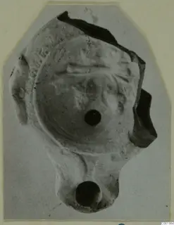 Terracotta oil lamp fragment from Soli, seen from above on a mounted print.