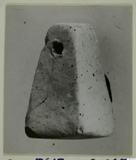 Tapering terracotta object with a round hole near its top, photographed on a grey card mount