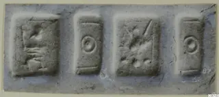 Four rectangular seal faces in a row, each with a simple incised motif.
