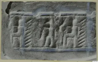 Glyptic design carved in relief on stone, with a standing figure between two seated figures