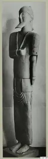 Neo-Cypriote terracotta statue of a standing figure with a long beaked nose and a close-fitting cap