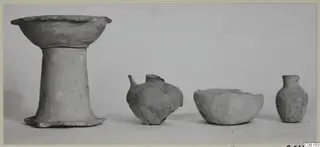 Four pottery vessels from Ayia Irini: a footed bowl, a round-bodied jug, a low bowl and a small narrow-necked jug.