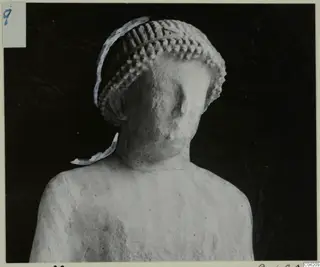 Limestone statue from Kition, head and upper torso, with a ridged cylindrical headdress