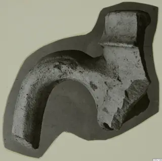 Pottery sherd with a thick curved handle, shown on a grey cut-out card mount