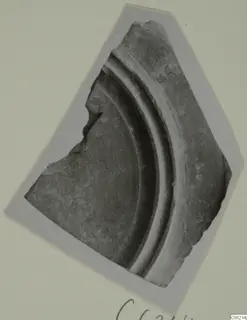 Curved sherd with raised concentric moulded ridges, shown on a grey photo card mount