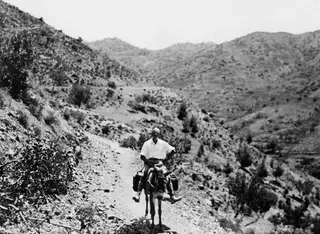 John Lindros riding a donkey along a stony mountain track at Machairas