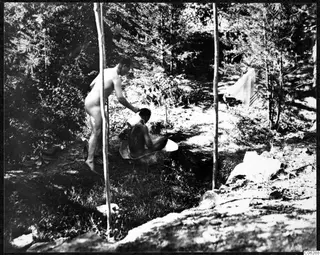 Two men bathing in a forest clearing at Machairas.