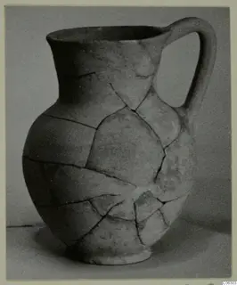 Pottery Plain White VI jug with a single handle, reassembled from broken pieces
