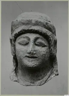 Limestone head of a figure with closed eyes and a close-fitting cap, from Kition