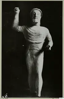 Limestone Cypro-Greek I statuette of a standing bearded male figure with one fist raised, from Kition