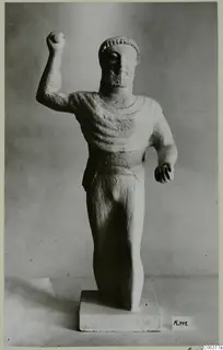 Limestone statue of a bearded male figure with one fist raised, from Kition