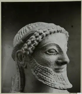 Limestone head from Kition, shown in right profile against a dark background