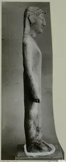 Limestone statue of a standing figure in side view on a square base, from Kition
