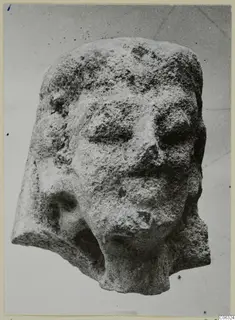 Limestone head fragment from Kition with worn face, broken at the back and lower left