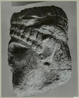 Limestone sculpture fragment from Vouni with a ridged band and incised diagonal lines on a rounded form