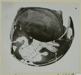 Pottery sherd from Vouni, red figured ware, with dark glossy surface and pale painted pattern of dots and lines.